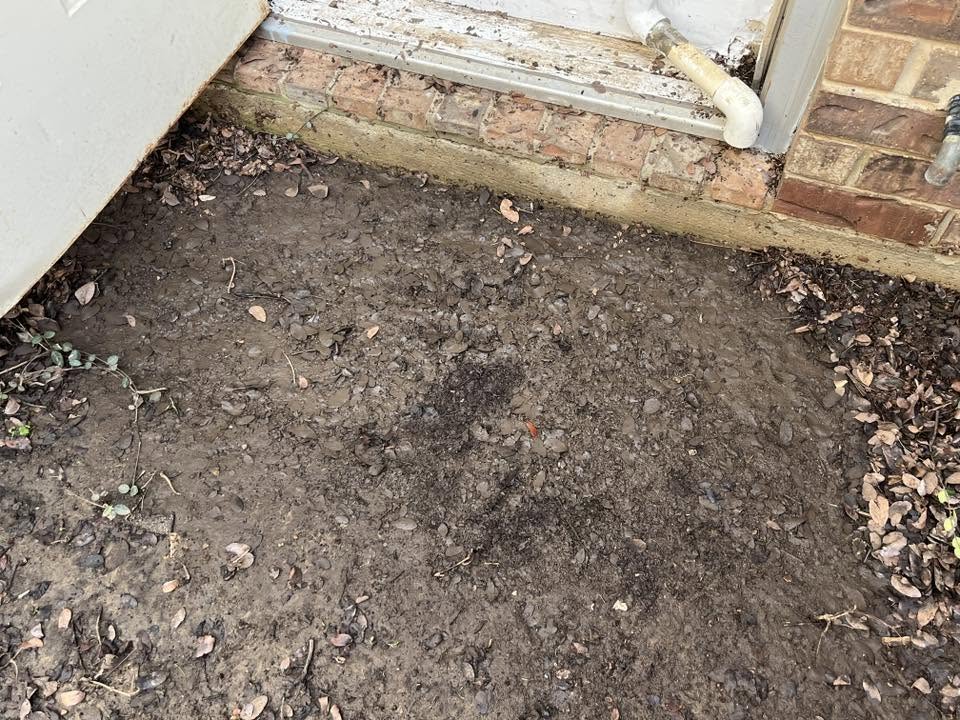 Exterior area beside a house where water collects after heavy rain